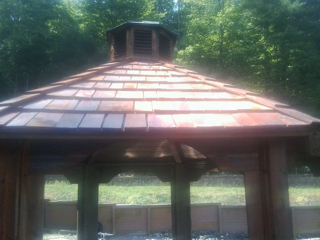 New cedar shake roof and cupola on a lakeside gazebo in Harvest